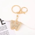 Close-up of golden letter W keychain with sparkling crystals and lobster clasp - Letter W