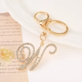 Golden zinc alloy letter H keychain with sparkling white rhinestones on white plate - Letter W(W) / Gold