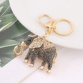 Detailed view of golden elephant keychain with sparkling rhinestones on a white plate - Gray Rhinestone Full Diamond Elephant (Color 17)