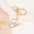 Detailed close-up of golden letter E keychain with sparkling white rhinestones - Letter Y(Y) / Gold