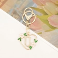 Detail view of heart-shaped letter U keychain with pink flowers and sparkling rhinestones - Letter U Style