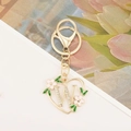 Detailed macro view of a heart-shaped golden letter W keychain with rhinestones - Letter W Style