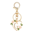 Golden heart-shaped keychain featuring letter G with rhinestones and pink flowers - Letter G Style