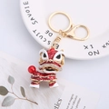 Traditional red enamel lion dance keychain with white crystals and golden key ring - Red