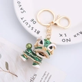 Chinese lion dance keychain in emerald green enamel with gold plating and sparkling rhinestones - Green