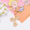 Golden butterfly keychain with sparkling rhinestones and lobster clasp on floral background - Gold
