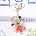 Detailed view of ox keychain with glittering rhinestones and bright red enamel finish - 6.2cm x 5cm / Red
