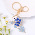Detail of goldfish keychain in gold alloy with blue rhinestones and white enamel details - Blue
