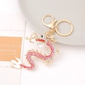 Squisito portachiavi drago cinese con strass rosa e bianchi su base in metallo dorato - Rosa