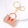Portachiavi borsa in metallo dorato con fiocco rosso e strass scintillanti - Stile a Strisce Rosse e Bianche con Fiocco