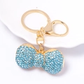 Portachiavi con fiocco dorato e strass blu su piatto di ceramica bianca, ciondolo borsa - Blu Lago