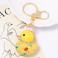Detail of yellow resin crown duck keychain with colorful rhinestones and golden lobster clasp - Pink Crown Duck