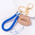 Detail of blue braided rope keychain with a sparkling champagne rhinestone lip charm - Champagne Lip with Blue Rope