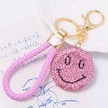 Pink rhinestone smiley face keychain with braided faux leather strap and golden metal ring - Pink Smiley Face With Leather Strap