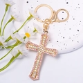 Cross keychain with pink and aurora crystals and golden clasp on a white surface - Cross Style 9