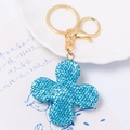 Macro detail of blue textured clover keychain with golden metallic ring and clasp - Blue Rhinestone Clover Pendant