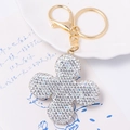 Macro detail of gold four-leaf clover keychain with sparkling clear rhinestones - White Rhinestone Clover Pendant