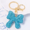 Bowknot keychain with blue rhinestones and gold-plated metal clasp on white background - Light Blue Rhinestone Bowknot Pendant (Color 2)