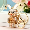 Close-up of golden zodiac bunny keychain with rhinestones and enamel details - Yellow