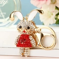 Close-up of golden rabbit keychain with sparkling rhinestones and lobster clasp - Red