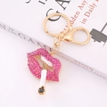 Chic gold-tone keychain with sparkling pink rhinestone lips and a cigarette charm pendant - Rose Red