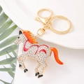 Golden horse keychain with sparkling crystals and orange enamel, featuring a lobster clasp - Red