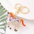 Detailed view of horse keychain with white rhinestones and orange gradient mane - Purple