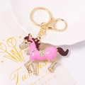 Detail of pink enamel horse keychain with sparkling rhinestones and golden ring hook - Pink