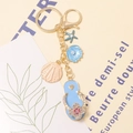 Elegant ocean themed golden keychain with blue flip flop, pink shell and starfish pendants - Ocean Beach Flip-flop Style (Color 1)