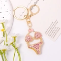 Detail of pink rhinestone bikini keychain with golden alloy finish and lobster clasp - Pink