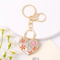 Elegante portachiavi a cuore con strass, motivi floreali e gemma di cristallo rosa - Fiore Rosso
