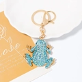 Detailed view of frog keychain with light blue rhinestones on a decorative dish - Light Blue Style (A-561)