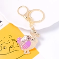 Close-up of golden dodo duck keychain with pink rhinestones and enamel details - Pink