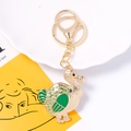 Detail of golden dodo bird keychain with green enamel and sparkling rhinestones - Green