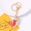 Macro view of dodo bird keychain featuring red enamel finish and sparkling rhinestones - Red