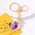 Golden dodo bird keychain with purple enamel wings and sparkling rhinestones - Purple