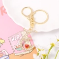 Detail of crystal letter E keychain with gold metal plating and small red heart charm - Letter E