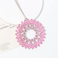 Macro shot of large pink sunburst crystal pendant with marquise stones and silver alloy base - Pink