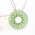 Macro detail of sunflower crystal pendant with marquise-cut light green stones - Green