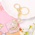 Detail of gold letter L keychain with sparkling rhinestones and a small red heart charm - Letter L