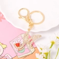 Detail shot of a crystal-studded letter K keychain with a small red heart and golden finish - Letter M