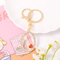 Close-up of golden letter O keychain with crystal rhinestones and red heart gem detail - Letter O