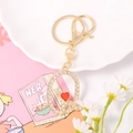 Detail view of crystal-encrusted gold letter Q keychain with small red heart charm - Letter Q