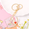 Detailed macro of crystal horseshoe keychain with red heart pendant on soft pink background - Letter U