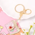 Detail of golden letter X keychain with crystals, red heart gem and moon charm - Letter X
