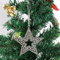 Detailed view of silver snowflake star ornament hanging on a Christmas tree branch - Hollow Five-pointed Star Design (Style 3)