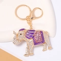 Detail of golden elephant keychain with sparkling rhinestones and purple enamel finish - Purple
