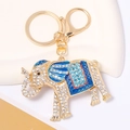 Detail of golden elephant keychain with sparkling rhinestones and blue enamel finish - Blue