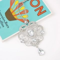 Macro shot of silver filigree snowflake pendant with sparkling rhinestones on blue prop - Style 3 (Heart Shape Hollow Scrolling Vine Design)