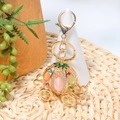 Detailed view of pumpkin carriage keychain with colorful opal stones and golden metal finish - Pink Orange With Green Stone Style (Color 3)